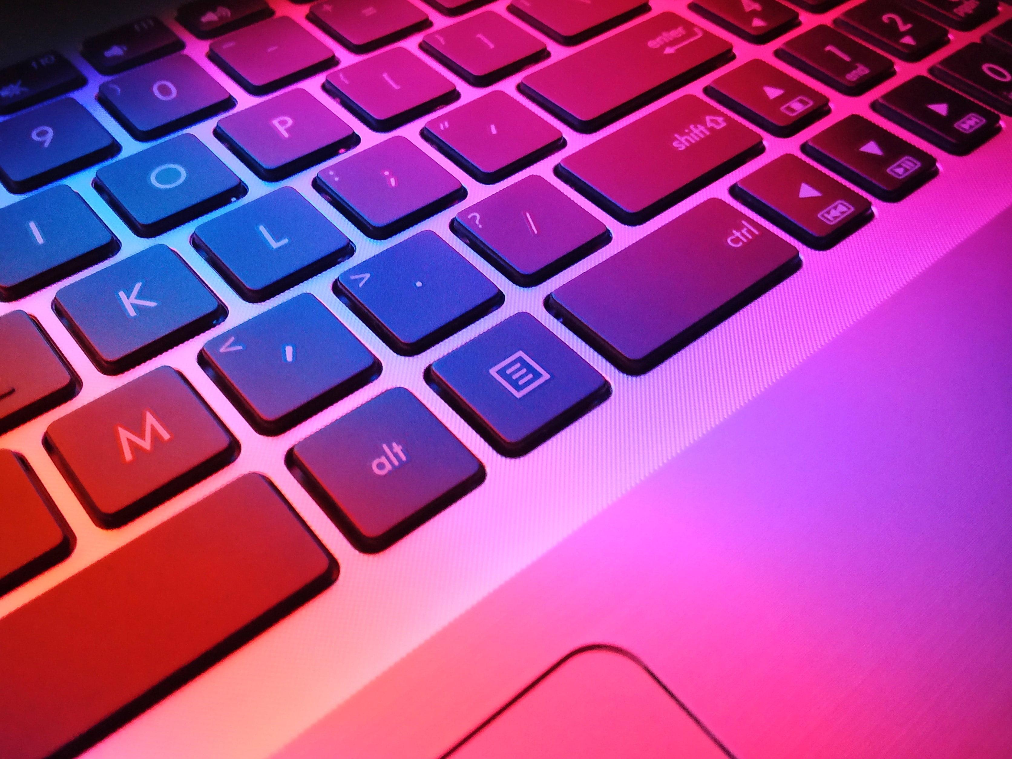 Laptop keyboard with pink and red lighting