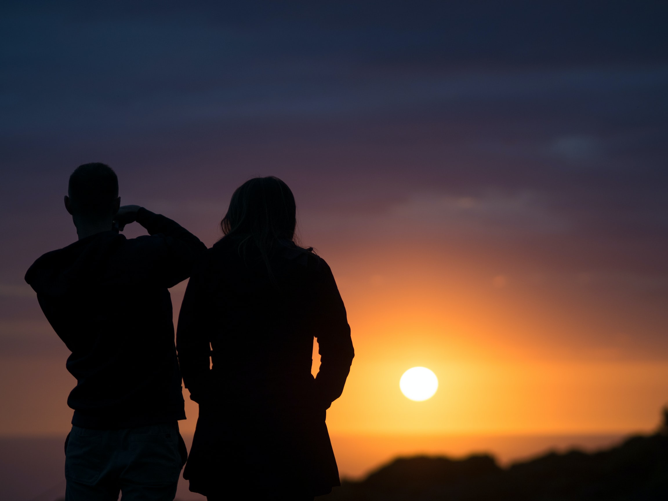A couple watching the sunset.